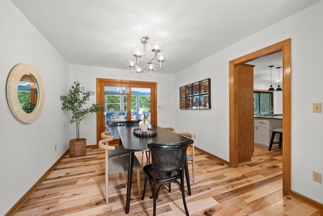 5657 Freeman Rd, Westerville, OH 43082 - dining room featuring light wood finished floors, a chandelier, and baseboards