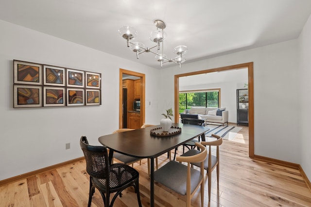 5657 Freeman Rd, Westerville, OH 43082 - dining space featuring a chandelier, light wood-style floors, and baseboards
