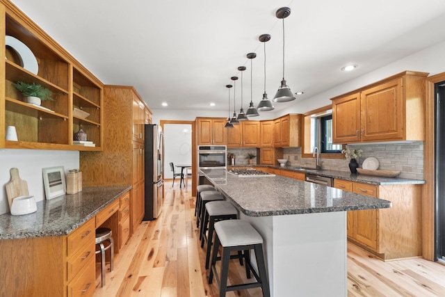 5657 Freeman Rd, Westerville, OH 43082 - kitchen featuring stainless steel appliances, a sink, a kitchen island, light wood finished floors, and recessed lighting