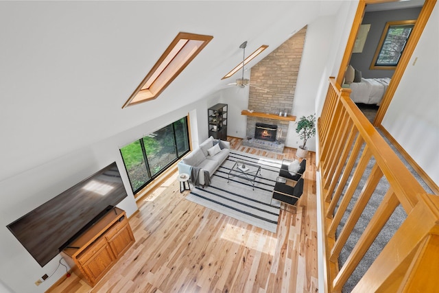 5657 Freeman Rd, Westerville, OH 43082 - living room with a warm lit fireplace, wood finished floors, healthy amount of natural light, a ceiling fan, and high vaulted ceiling