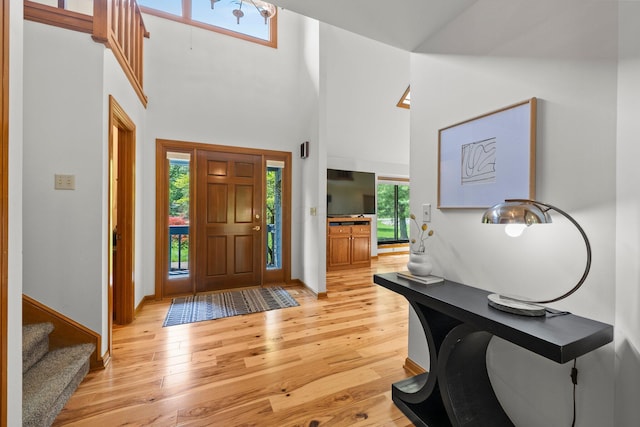 5657 Freeman Rd, Westerville, OH 43082 - foyer entrance featuring light wood finished floors, a high ceiling, stairs, and baseboards