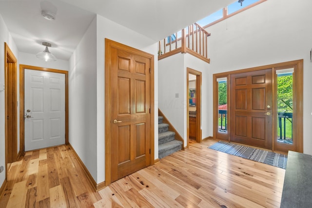 5657 Freeman Rd, Westerville, OH 43082 - foyer entrance featuring light wood-style floors, stairway, and baseboards