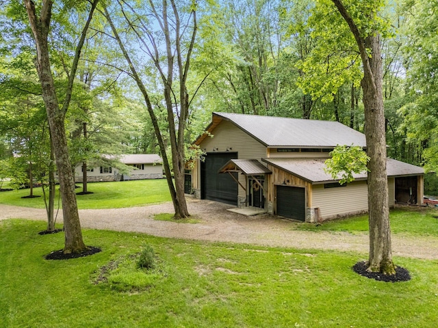 429 N Old State Rd, Delaware, OH 43015 - view of side of home featuring a yard, metal roof, dirt driveway, and an outbuilding