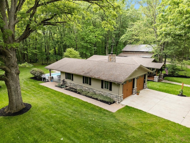 429 N Old State Rd, Delaware, OH 43015 - view of front of house with stone siding, a chimney, a shingled roof, and a front lawn
