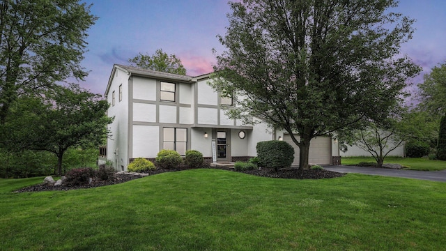 11600 Windridge Dr NW, Pickerington, OH 43147 - view of front facade featuring stucco siding, asphalt driveway, and a lawn