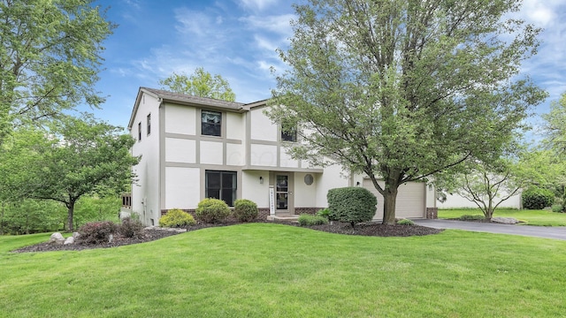 11600 Windridge Dr NW, Pickerington, OH 43147 - tudor home with stucco siding, driveway, a front lawn, and a garage