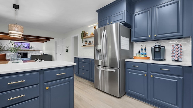 11600 Windridge Dr NW, Pickerington, OH 43147 - kitchen with stainless steel fridge with ice dispenser, blue cabinetry, light wood-type flooring, and open shelves