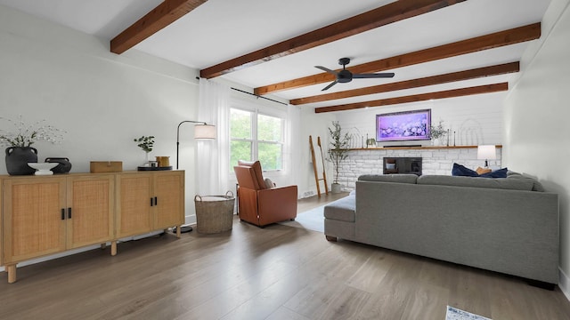 11600 Windridge Dr NW, Pickerington, OH 43147 - living area featuring light wood finished floors, ceiling fan, beam ceiling, and a stone fireplace