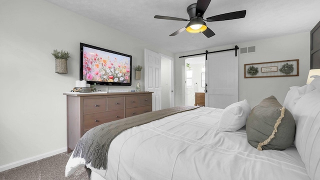 11600 Windridge Dr NW, Pickerington, OH 43147 - carpeted bedroom with a barn door, baseboards, and a ceiling fan