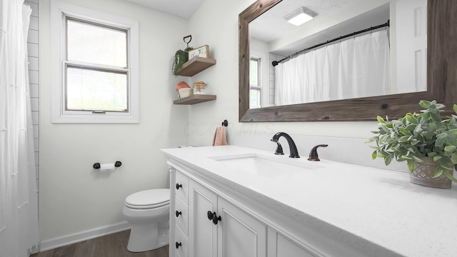 11600 Windridge Dr NW, Pickerington, OH 43147 - bathroom featuring vanity, toilet, wood finished floors, and baseboards