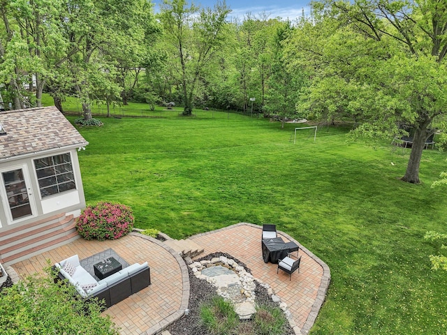 11600 Windridge Dr NW, Pickerington, OH 43147 - view of grassy yard featuring an outdoor fire pit, a patio, and an outbuilding