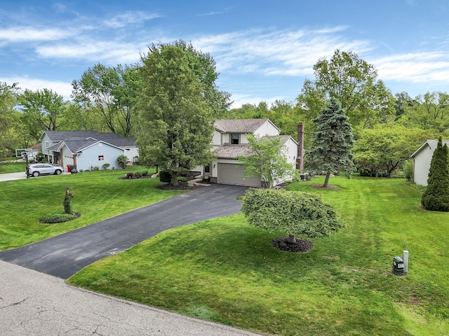 11600 Windridge Dr NW, Pickerington, OH 43147 - obstructed view of property with asphalt driveway, a front yard, and an attached garage