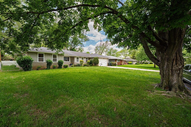 2747 Castlewood Rd, Columbus, OH 43209 - ranch-style home with a garage, driveway, a front lawn, and a chimney