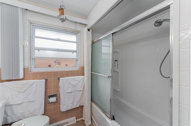 2747 Castlewood Rd, Columbus, OH 43209 - full bathroom featuring toilet, enclosed tub / shower combo, and tile walls