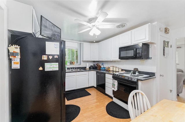 2747 Castlewood Rd, Columbus, OH 43209 - kitchen featuring black appliances, a sink, dark countertops, light wood-style floors, and ceiling fan