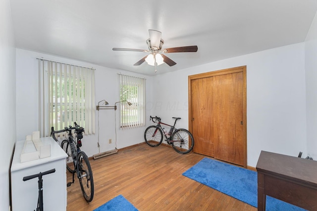 2747 Castlewood Rd, Columbus, OH 43209 - exercise area featuring a ceiling fan, light wood-style flooring, and baseboards