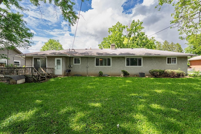 2747 Castlewood Rd, Columbus, OH 43209 - rear view of house featuring a wooden deck, a lawn, stucco siding, and a chimney