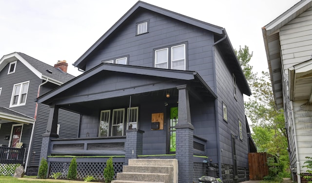 american foursquare style home with a porch