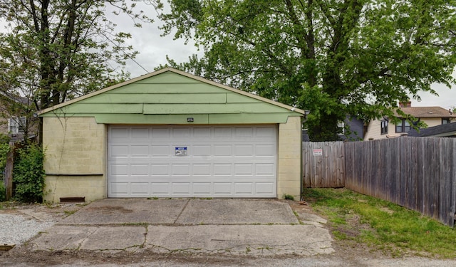 detached garage featuring fence
