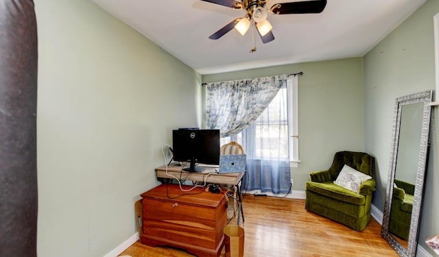 home office featuring wood finished floors, a ceiling fan, and baseboards