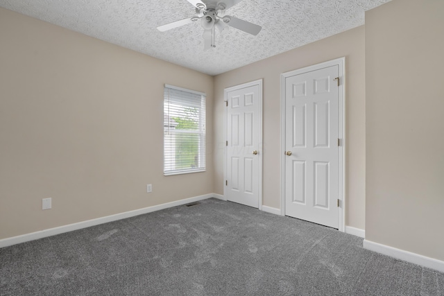 6289 Corley Dr, Dublin, OH 43016 - unfurnished bedroom with dark carpet, baseboards, a textured ceiling, and ceiling fan