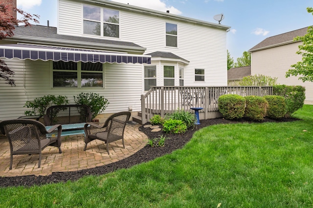 6289 Corley Dr, Dublin, OH 43016 - rear view of house with a patio area, a wooden deck, and a lawn