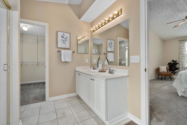 6289 Corley Dr, Dublin, OH 43016 - bathroom featuring a textured ceiling, baseboards, tile patterned flooring, a spacious closet, and a tile shower