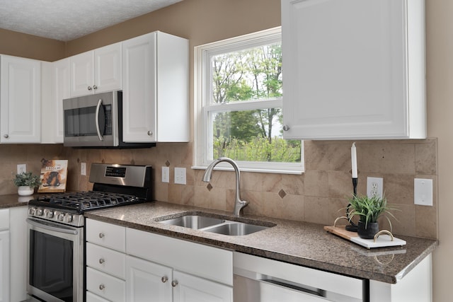 6289 Corley Dr, Dublin, OH 43016 - kitchen with stainless steel appliances, a sink, white cabinets, and backsplash
