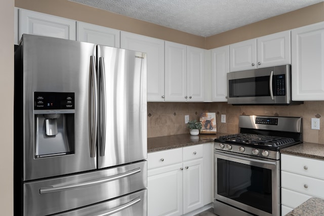 6289 Corley Dr, Dublin, OH 43016 - kitchen with stainless steel appliances, white cabinetry, a textured ceiling, and tasteful backsplash