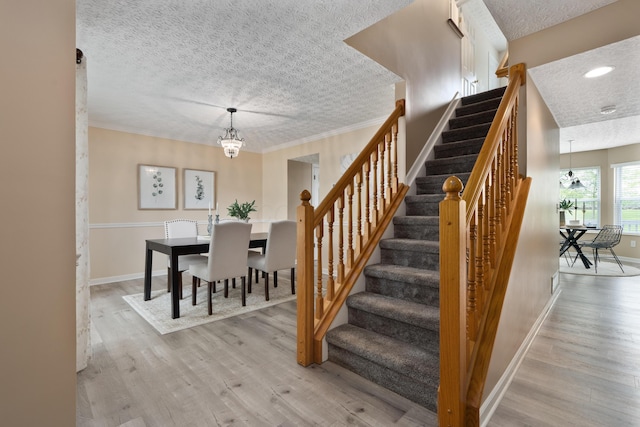 6289 Corley Dr, Dublin, OH 43016 - stairway with a textured ceiling, wood finished floors, baseboards, a chandelier, and recessed lighting