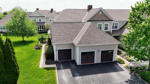 4020 Legend Unit 11, Columbus, OH 43230 - view of property exterior with driveway, roof with shingles, a lawn, an attached garage, and a chimney