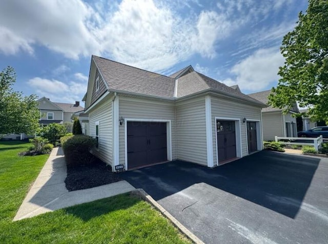 4020 Legend Unit 11, Columbus, OH 43230 - view of side of home featuring a garage, asphalt driveway, roof with shingles, and a yard