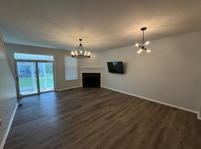 4020 Legend Unit 11, Columbus, OH 43230 - unfurnished living room with a chandelier, baseboards, dark wood-style floors, and a fireplace