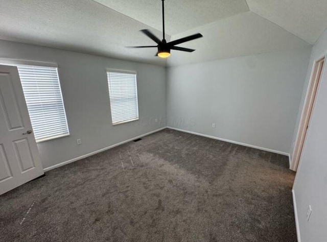 4020 Legend Unit 11, Columbus, OH 43230 - unfurnished bedroom featuring dark colored carpet, vaulted ceiling, baseboards, a ceiling fan, and a textured ceiling