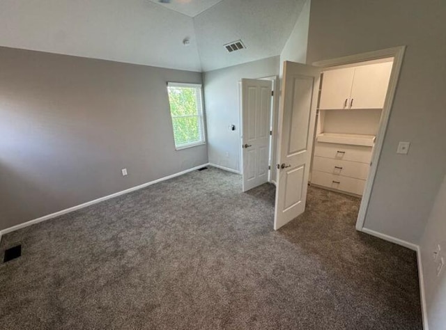 4020 Legend Unit 11, Columbus, OH 43230 - unfurnished bedroom with dark colored carpet, vaulted ceiling, and baseboards