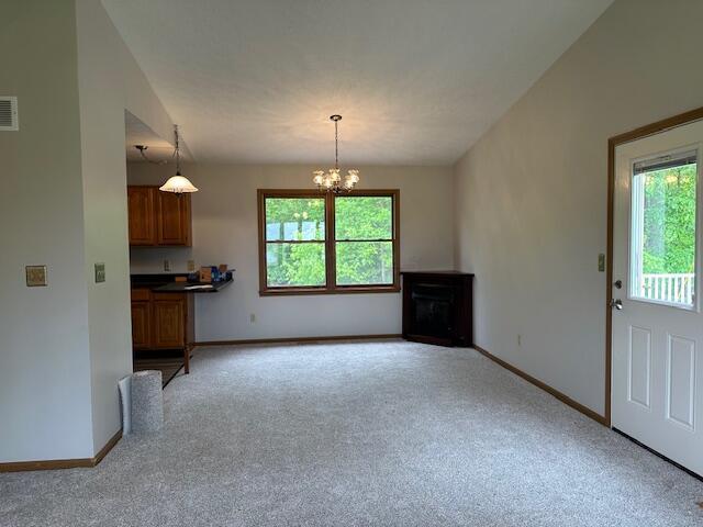 50 Stagecoach Rd, Chillicothe, OH 45601 - unfurnished living room with healthy amount of natural light, light carpet, and baseboards