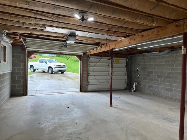 50 Stagecoach Rd, Chillicothe, OH 45601 - garage featuring a garage door opener and concrete block wall