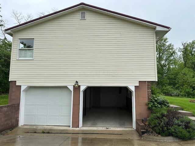 50 Stagecoach Rd, Chillicothe, OH 45601 - view of side of home with concrete driveway and a garage