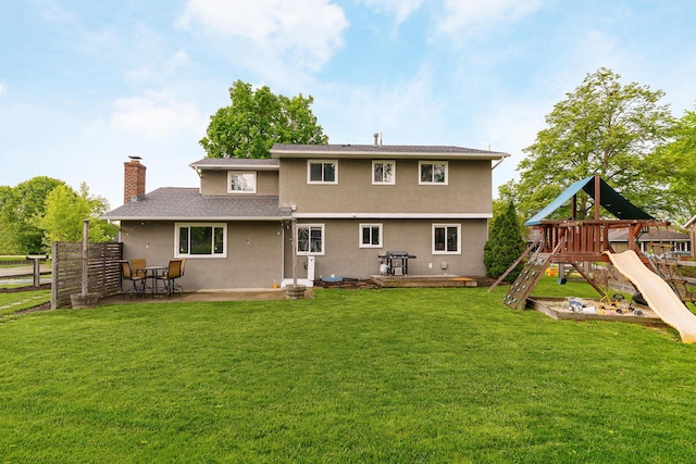 1671 Dollivor Dr, Columbus, OH 43235 - back of property featuring stucco siding, a chimney, a patio area, a playground, and a wooden deck