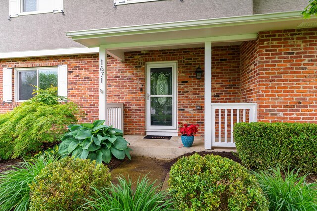 1671 Dollivor Dr, Columbus, OH 43235 - entrance to property with a porch, brick siding, and stucco siding