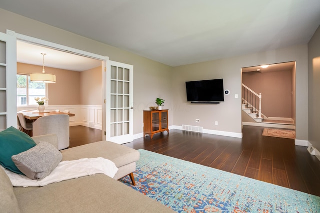 1671 Dollivor Dr, Columbus, OH 43235 - living room with wood finished floors, stairway, and baseboards