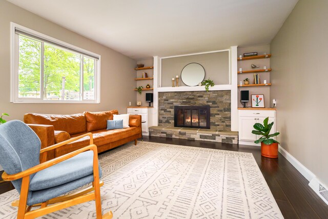 1671 Dollivor Dr, Columbus, OH 43235 - living area with dark wood finished floors, a fireplace, baseboards, and built in features