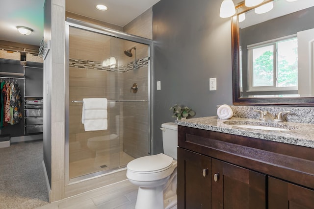 1671 Dollivor Dr, Columbus, OH 43235 - full bath with a shower stall, vanity, toilet, a walk in closet, and recessed lighting
