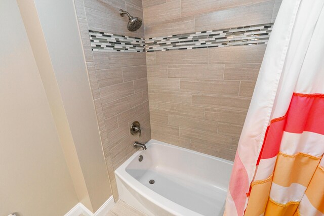 1671 Dollivor Dr, Columbus, OH 43235 - bathroom featuring shower / bathtub combination with curtain and baseboards