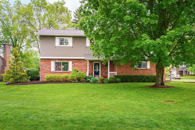 1671 Dollivor Dr, Columbus, OH 43235 - view of front of home featuring a front yard, brick siding, stucco siding, and a shingled roof