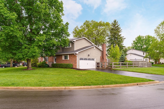 1671 Dollivor Dr, Columbus, OH 43235 - view of front of home featuring asphalt driveway, stucco siding, a chimney, and brick siding