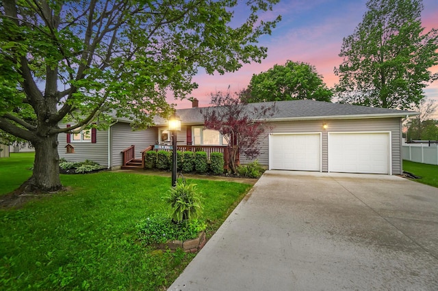 56 W Xenia St, Jamestown, OH 45335 - view of front of property featuring a garage, driveway, and a lawn