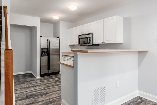5962 Thunder Gulch Dr, New Albany, OH 43054 - kitchen with stainless steel appliances, dark wood finished floors, white cabinets, baseboards, and a peninsula