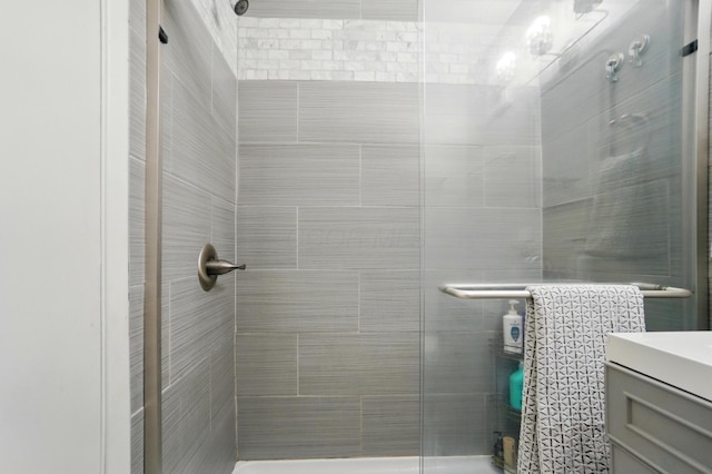 full bathroom with a shower stall and vanity