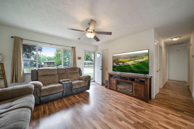 3233 Burdett Ct, Columbus, OH 43232 - living area with wood finished floors, a textured ceiling, and ceiling fan